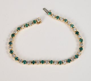 14K gold, diamond, and emerald inline bracelet, lg. 7".