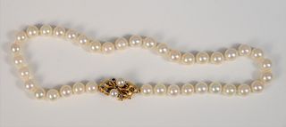 Single strand of pearls with 14K gold clasp mounted with pearls and blue sapphires, 15", 8.7mm.