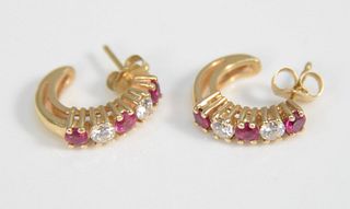 Pair 14K gold pierced earrings with two diamonds and three red stones, 3.4 gr. each.