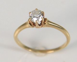 14K gold diamond engagement ring having approximately half carat diamond.