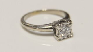 18k white gold ring set with center diamond approximately .60ct. 
Size 4 1/4.