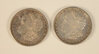 Two 1878 S Morgan silver dollars, uncirculated.