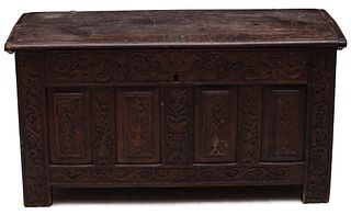 A 17TH CENTURY CARVED AND PANELED OAK COFFER