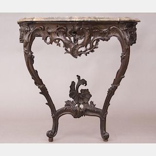 A Continental Carved Walnut and Marble Top Console, 19th Century.