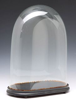 A 19TH CENTURY OVAL BLOWN GLASS CLOCK DOME