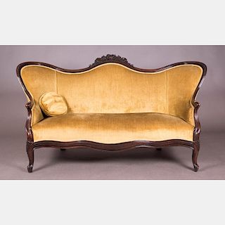 A Victorian Carved Walnut Settee, 19th Century.