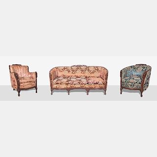 A Heavily Carved and Upholstered Sofa and Two Club Chairs, 20th Century.