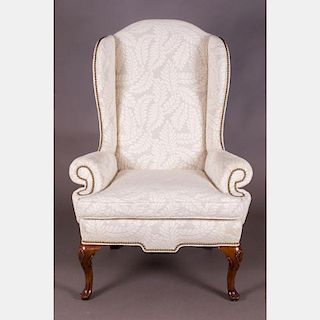 A Queen Anne Style Wing Back Upholstered Armchair, 20th Century.