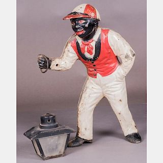 A Cast Iron Painted Lawn Jockey with Lantern, Early 20th Century.