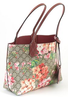 Gucci Blooms Supreme Beige Coated Canvas Reversible Tote Shoulder Bag, the exterior with a floral print and plum colored leather and...