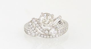 Lady's Platinum Dinner Ring, with a .9 ct. round diamond, centering baguette diamondmounted rods and curved split diamond mounted ba...