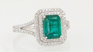 Lady's Platinum Dinner Ring, with a 1.93 ct. emerald atop a double concentric graduated octagonal border of tiny round diamonds, the...