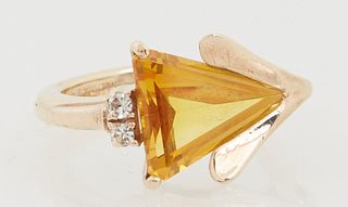Lady's 14K Yellow Gold Dinner Ring, with a horizontal trillion cut citrine, flanked by two small diamonds on one side and a 14K yell...