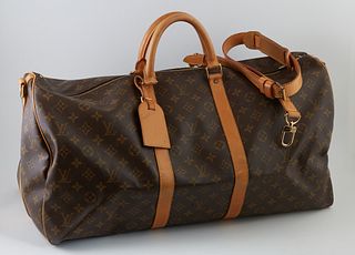 Louis Vuitton Brown Monogram Coated Canvas 55 Keepall Bandouliere Travel Bag, the vachetta leather handles and adjustable shoulder s...