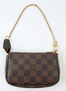Louis Vuitton Brown Mini Accessory Pouch, damier ebene coated canvas with a golden brass zipper and chain handle, opening to single ...