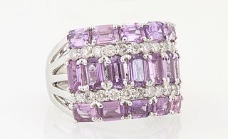 Lady's 18K White Gold Dinner Ring, the tapered band with a central vertical row of emerald cut non-heated pink sapphires, flanked by...