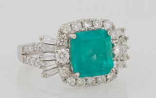 Lady's Platinum Dinner Ring, with a 3.73 ct. octagonal emerald, atop a border of round diamonds, flanked by baguette diamond mounted...