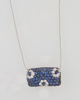18K White Gold Pendant, of curved rectangular form, mounted with numerous small blue sapphires, and small white diamonds, on a tiny...