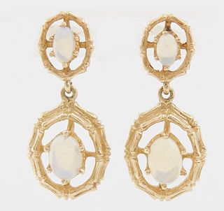 Pair of 14K Yellow Gold Pendant earrings, the stud with a small oval cabochon opal within a pierced gold frame, suspending a larger ...