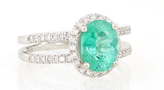 Lady's Platinum Dinner Ring, with an oval 1.94 ct. Paraiba turquoise, atop a border of small round diamonds, the split shoulders of ...