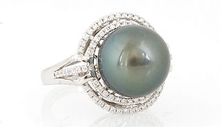 Lady's Platinum Dinner Ring with a 13mm Tahitian dark grey cultured pearl atop a pierced graduated double concentric border of tiny...