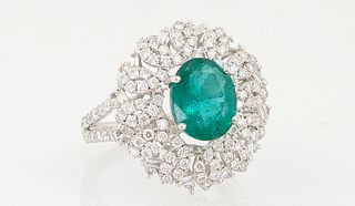 Lady's Platinum Dinner Ring, with a 2.67 ct. oval emerald, atop a pierced floriform border mounted with 128 small round diamonds, to...