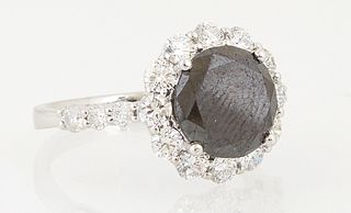 Lady's 14K White Gold Dinner Ring, with a circular 3.03 ct. black diamond, atop a border of round white diamonds, the shoulders of t...