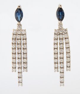 Pair of 18K White Gold Pendant Earrings, each stud with a .61 ct., oval sapphire, issuing three diamond mounted tassels, total sapph...