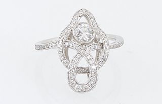 Lady's Platinum Dinner Ring, with a .32 ct. round diamond atop a pierced diamond mounted intertwined top, joining a bypass band moun...