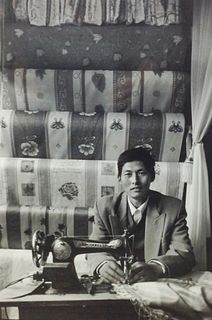 Black and White Photo of man sewing upholstery