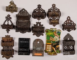 Twelve cast iron and tin wall mount match safes
