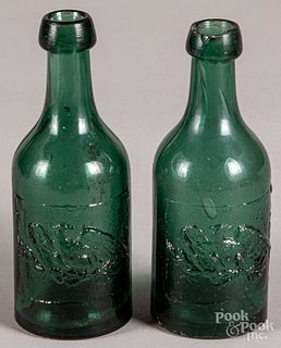 Two embossed eagle blob top green soda bottles