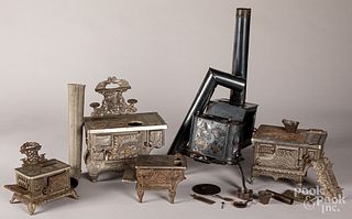 Four cast iron toy stoves