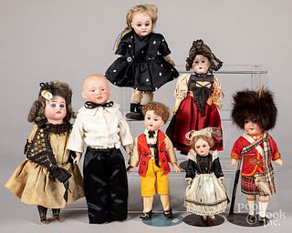 Seven small bisque head dolls