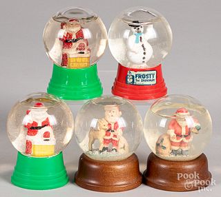 Five vintage Christmas snow globes.