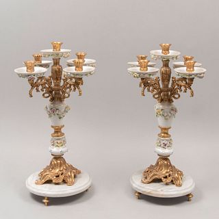 Par de candelabros. Siglo XX. Elaborados en porcelana tipo Capodimonte con bases de ónix y metal dorado. Para 5 luces.