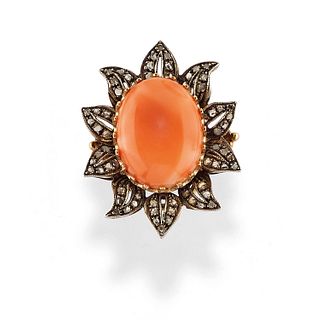 A silver, 14K yellow gold, coral and diamond ring