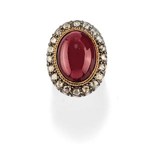A silver, 18K yellow gold, garnet and diamond ring, first half of 20th Century