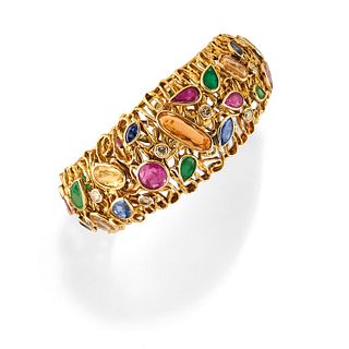 A 18K yellow gold, diamond, emerald, ruby, sapphire and colored gemstones bangle