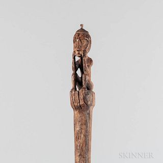 Dayak Tun Tun Stick, West Kalimantan, Borneo, Indonesia, seated figure with elbows on its knees, eroded surface, lg. 21 1/2 in.