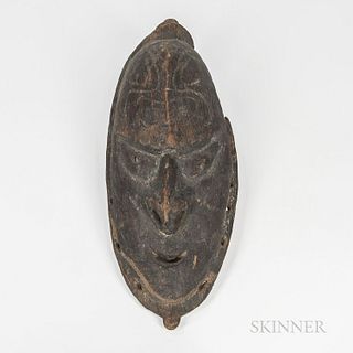 New Guinea Wood Mask, Lower Sepik River region, early 20th century, ancestor mask, with cutout mouth and eyes, and pierced septum, pier