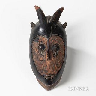 Guro Bete Face Mask, hollowed-out zoomorphic mask, with small, open mouth, long narrow nose, and protruding eyes, with incised brows be