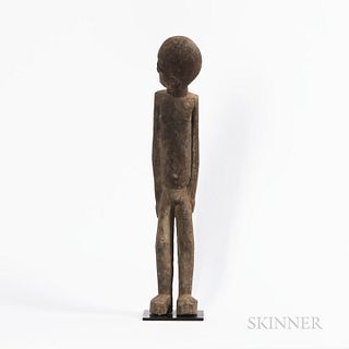 Lobi Figure, Burkina Faso, standing on heavy feet, with long legs, arms held at the side and head turned to the right, encrusted patina
