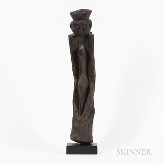 Chamba Figure, Nigeria, rising from a cylindrical base, the figure with elongated arms, narrow torso and abstracted head with simply de