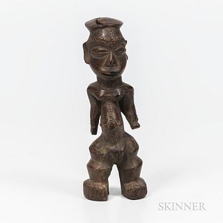 Montol Female Figure, Benue River region, Nigeria, standing on heavy feet, with squat legs apart, the elongated and protruding abdomen