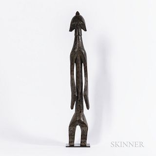 Standing Mumuye Figure, Nigeria, thick angular legs below an elongated torso with two protruding belly buttons, long cutout arms at sid