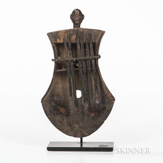 Thumb Piano, Kasanji, Luba, Congo, early 20th century, wood and metal, mounted on a metal stand, ht. 8 1/2 in.Provenance: Eric Robertso