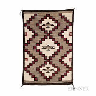 Navajo Rug, c. 1950s, the dark border with central stepped diamond devices on a gray ground, with repeated half diamond devices on eith