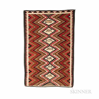 Navajo Eye-dazzler Rug, the edge fringed in cotton, the serrated long borders contain the multicolored serrated dazzler pattern, centra