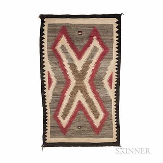 Navajo Rug, c. 1930s, woven on a gray ground, with central serrated "X" design, the dark border with sawtooth design on each long side,